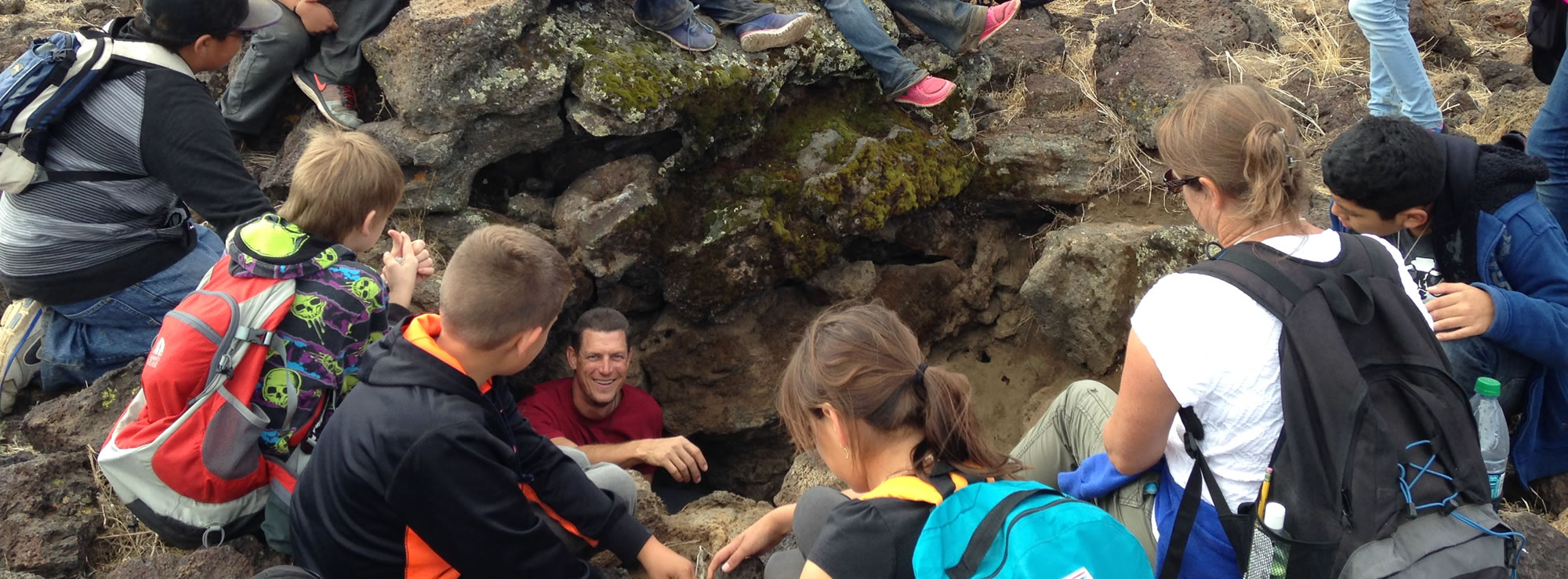 Students exploring lava tubes on Crater Mountain during Science Camp