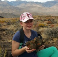 Girl with lichen covered lava rock